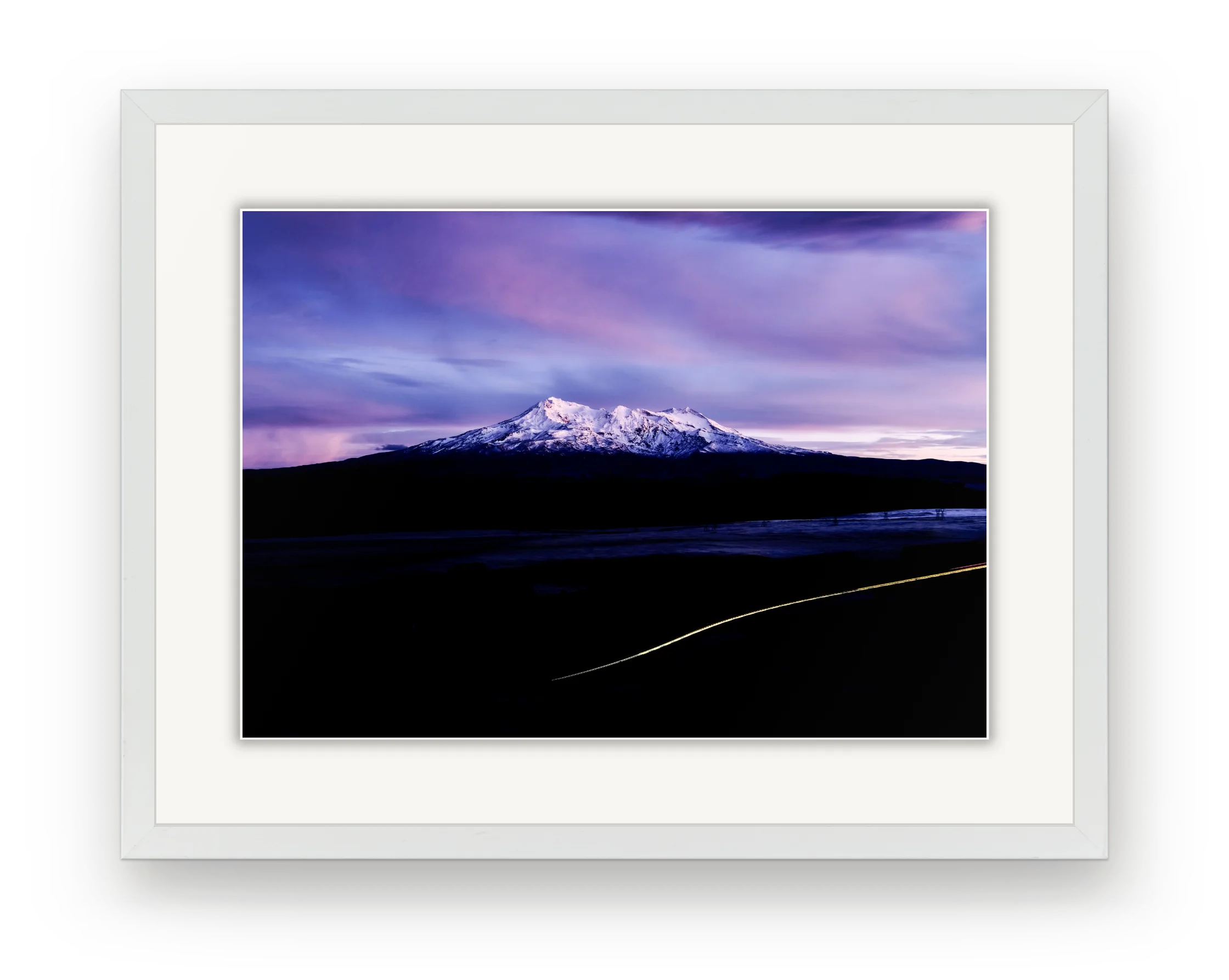A photograph of Ruapehu under a lilac sky in a white frame with a white mat.