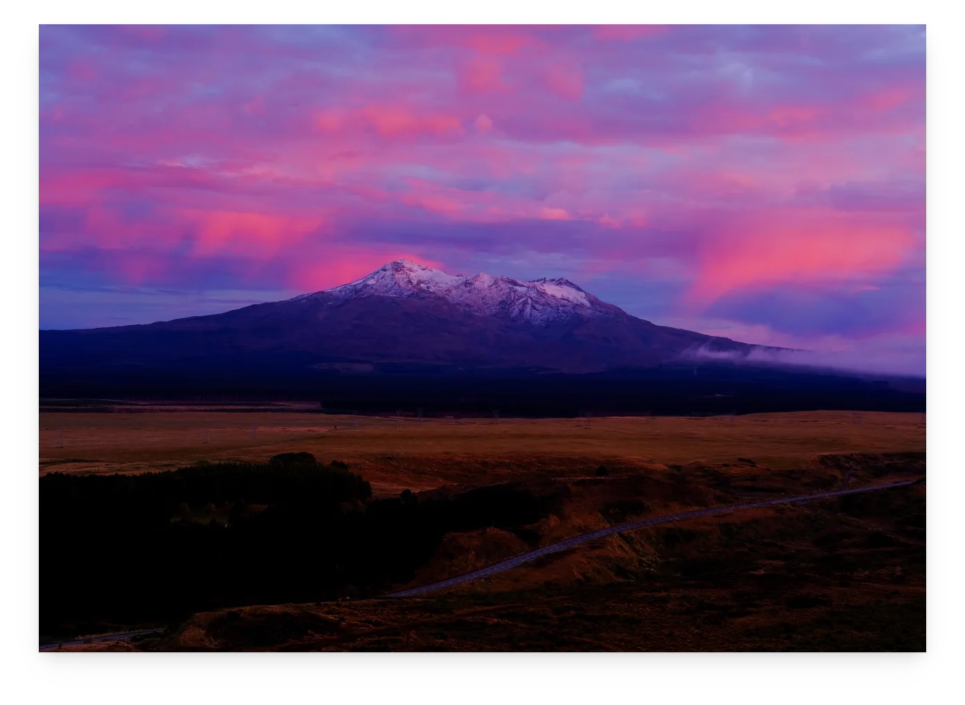 An unframed print of Ruapehu under pink cloud.