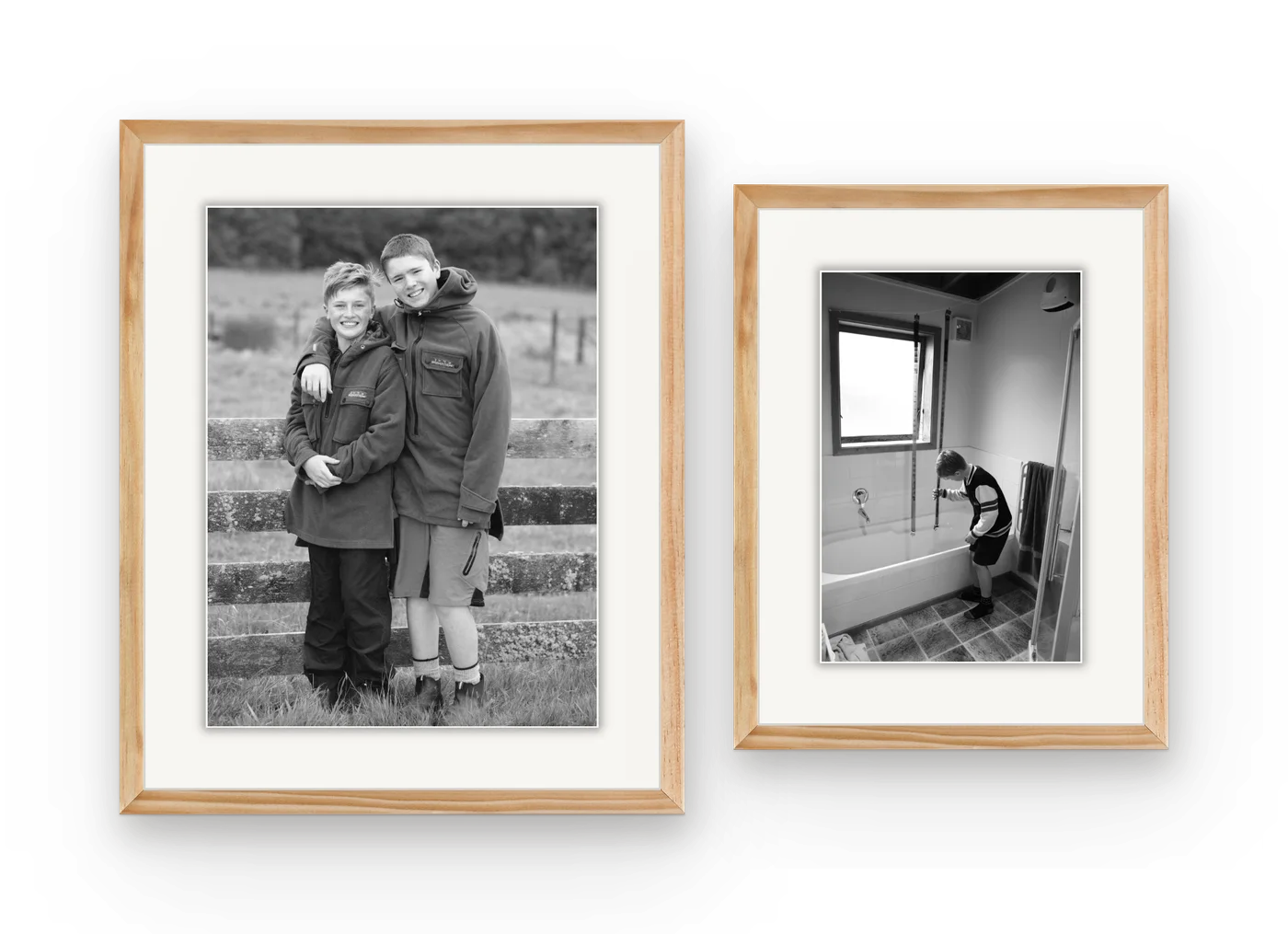 Two black and white family photographs in matching natural wood frames, hung side by side.